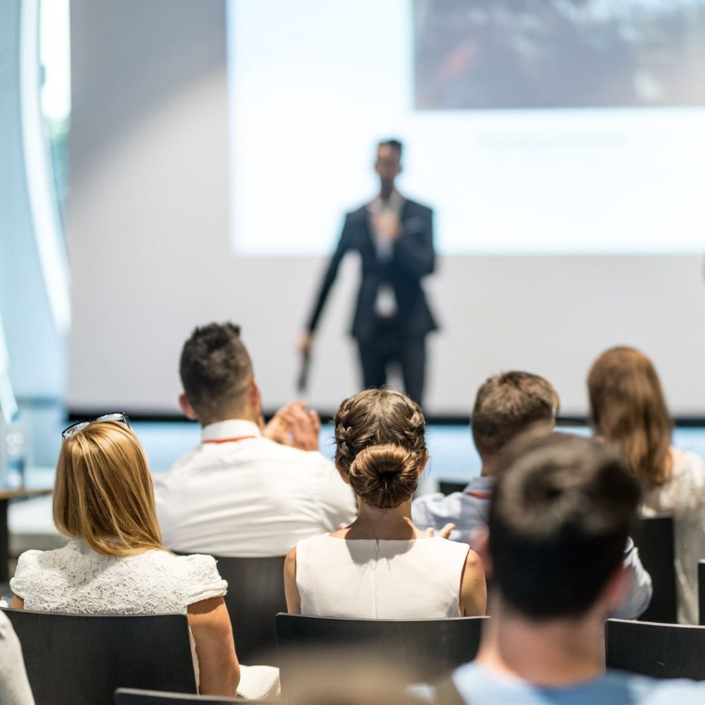 A team watching a presentation being given